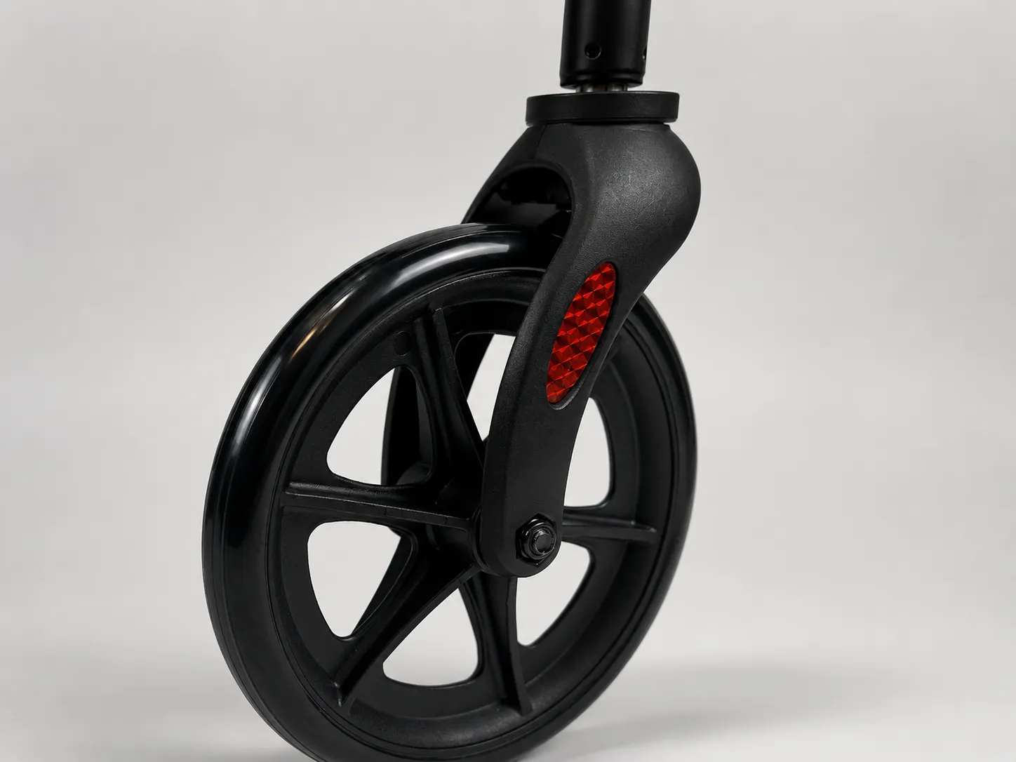 Close-up of the EazyFold rollator's large 8-inch textured wheel and swivel caster with safety reflector.