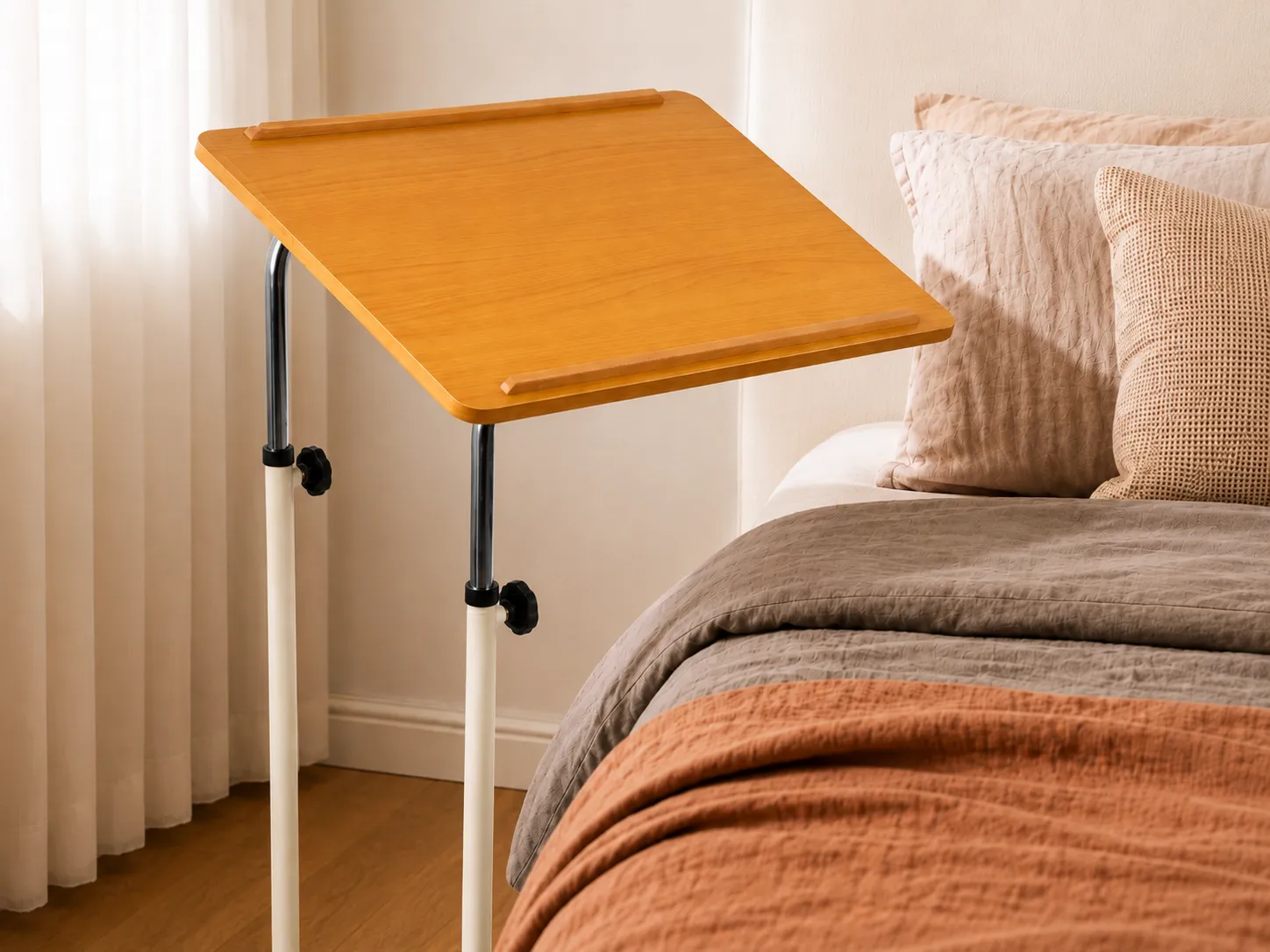 Close-up of the Eazy Glide overbed table's beech top tilted to a reading angle with a raised anti-slip edge.