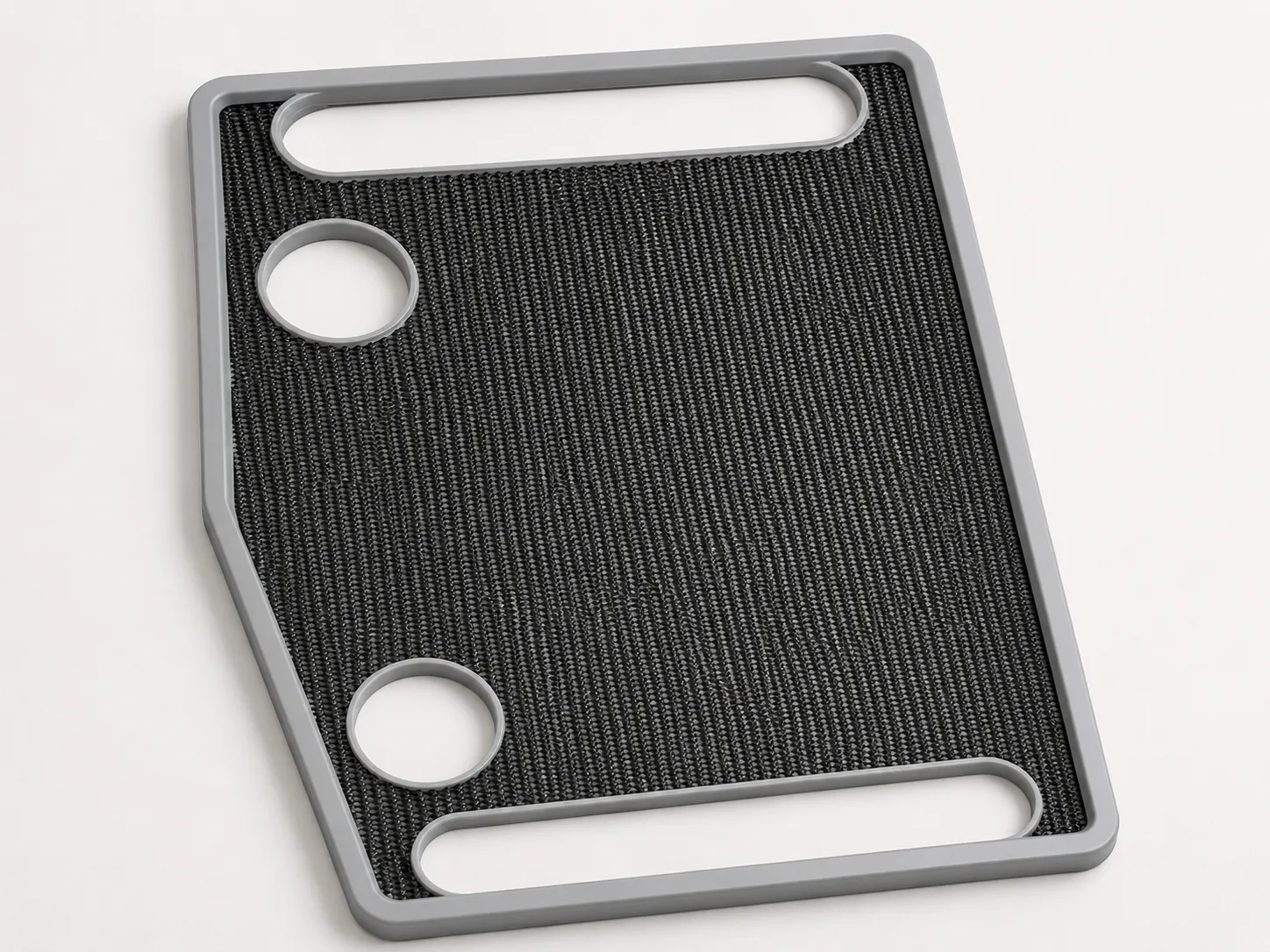 The walking frame's removable grey tray with non-slip textured surface, two cup recesses and carry-handle slots.